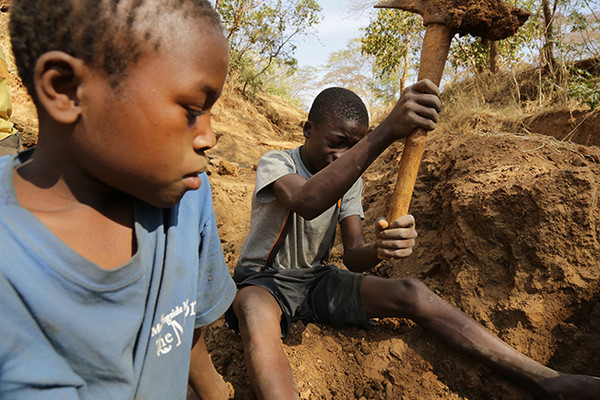 Two 13 year old boys digging for gold in a mine in Mbeya region, Tanzania. (c) 2013 