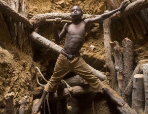 Nine-year-old Karim Sawadogo works with his uncle at a gold mine in Burkina Faso. Photo by Larry C. Price.